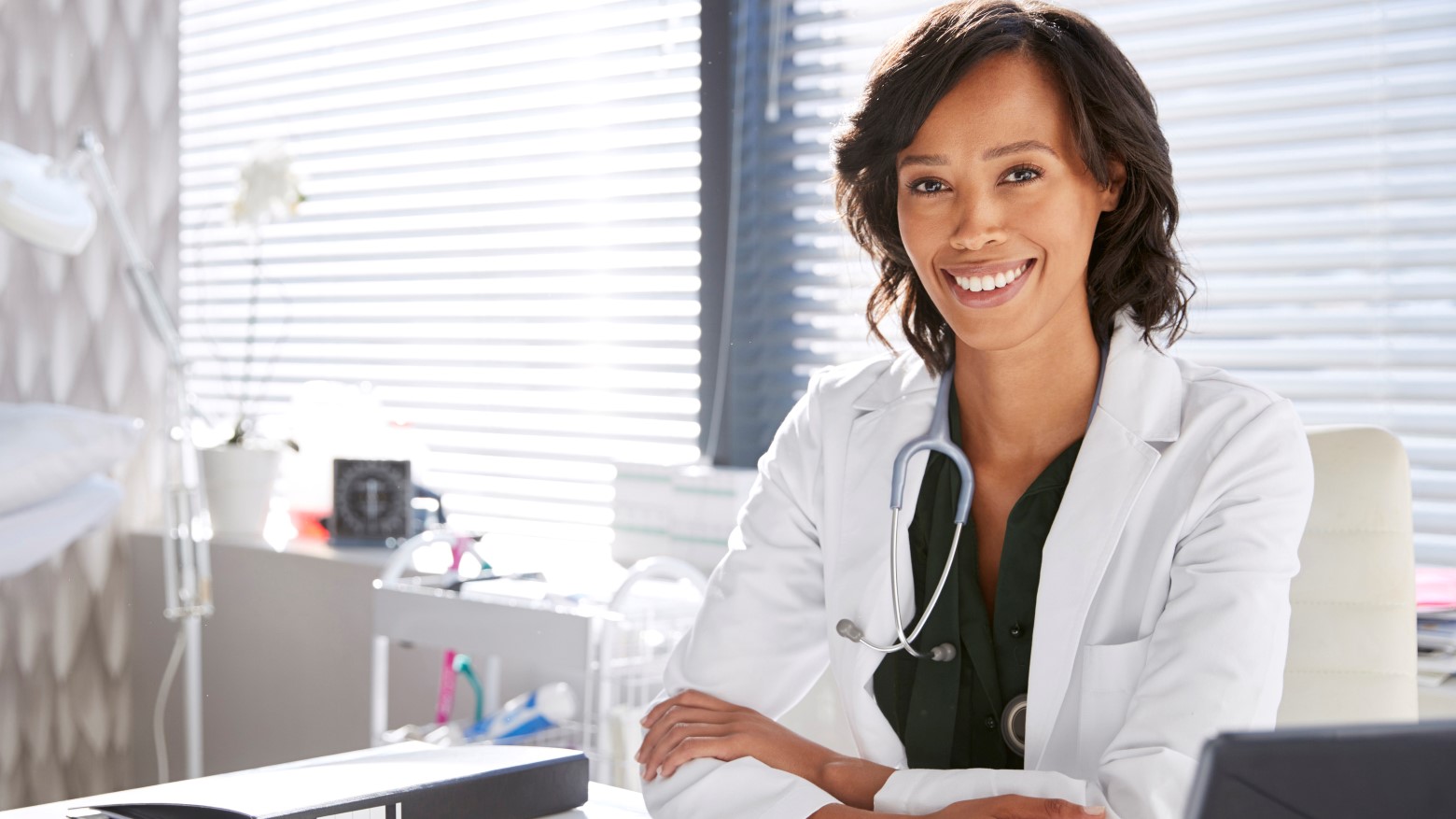 female doctor at desk smiling