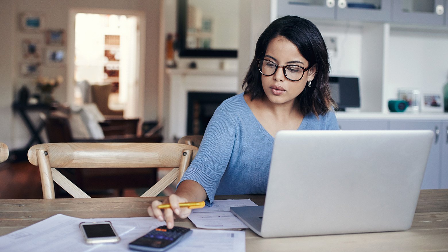 A female student works on her laptop at home