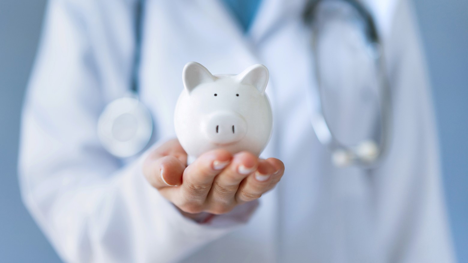 doctor holding a piggy bank