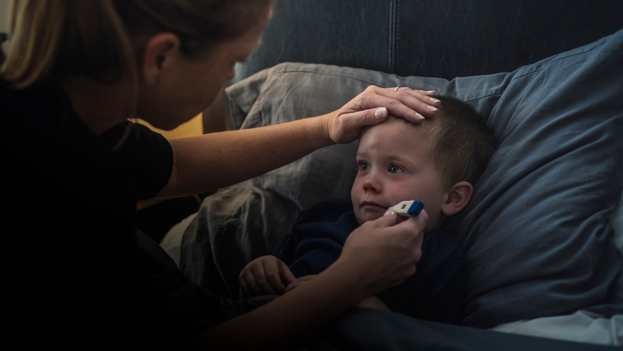 A mother checking her child's temperature