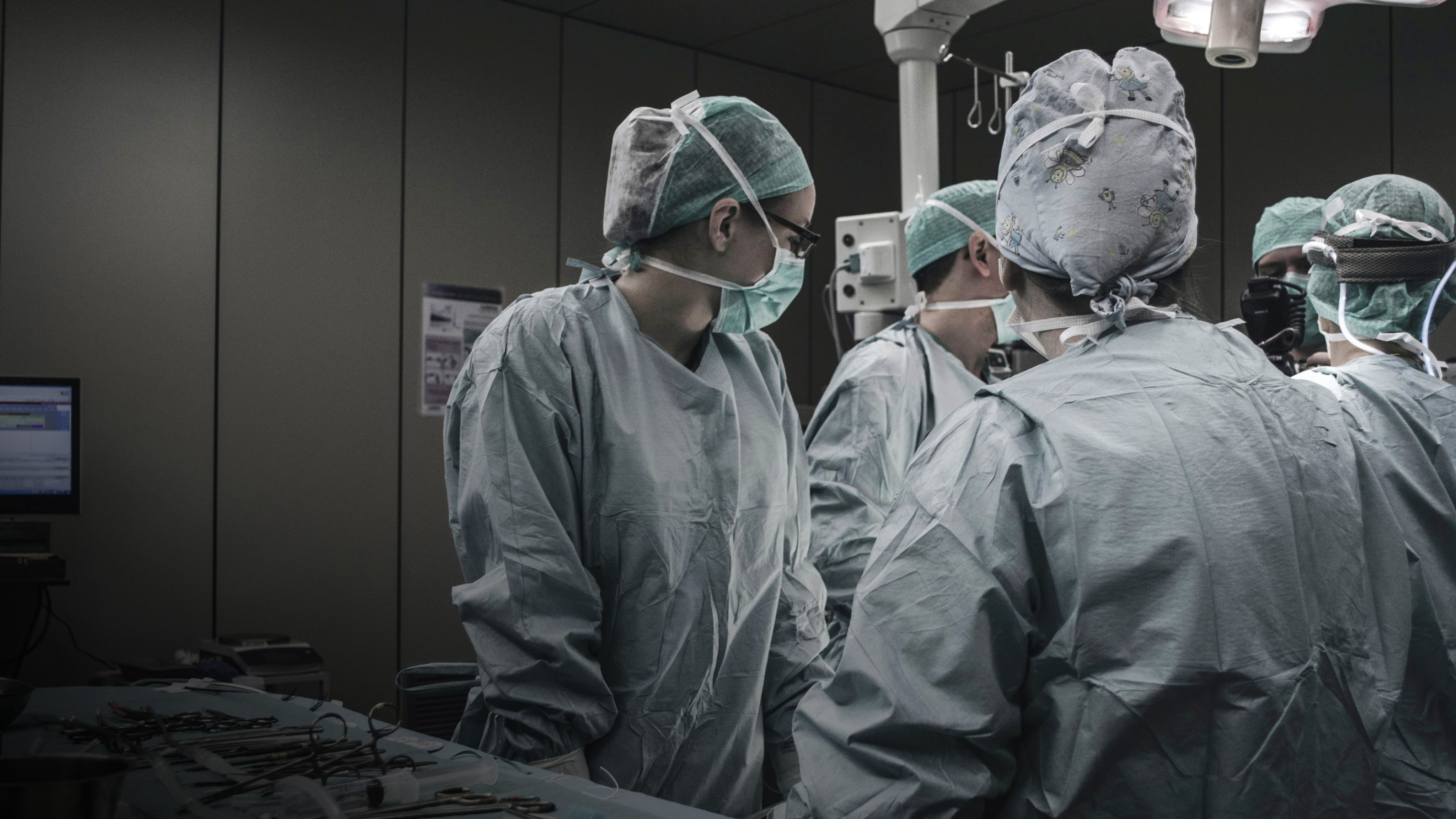 Doctors wearing PPE in an operating room