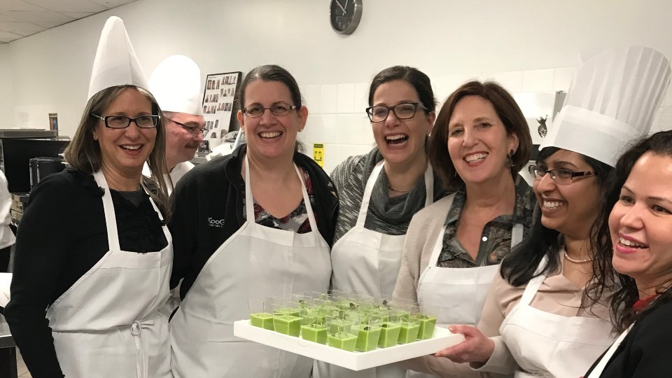 Board members volunteering in the kitchen at a fundraising event