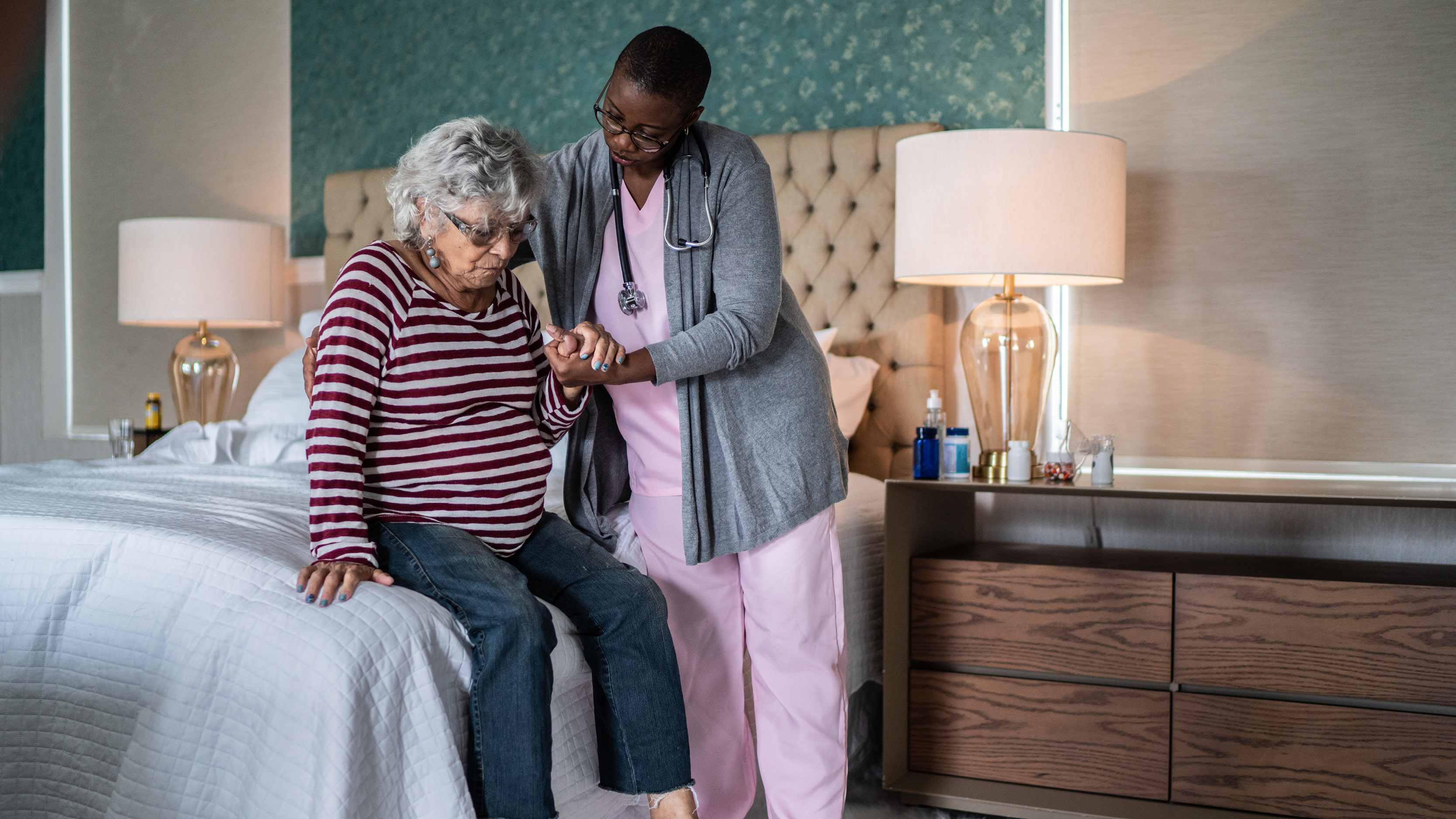 a physician helping an elderly woman 